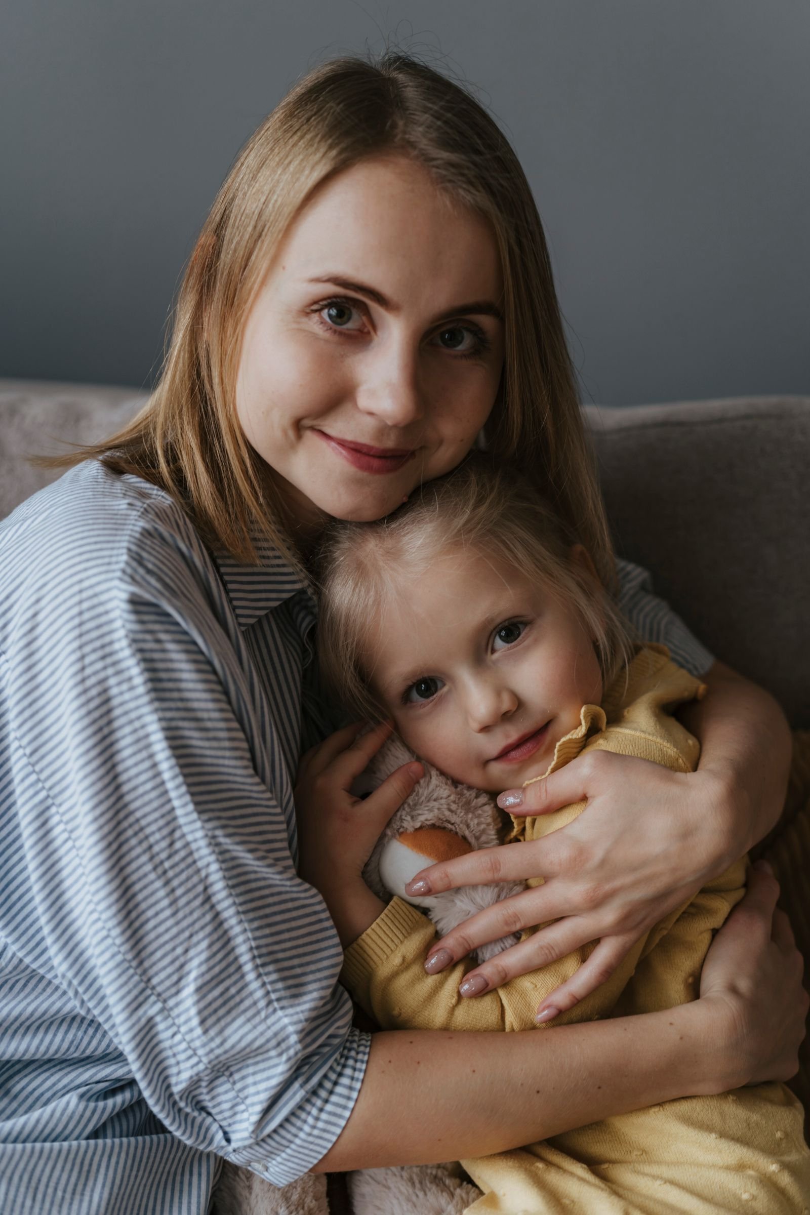 A mother holding her young child close, the family at the center of everything we do